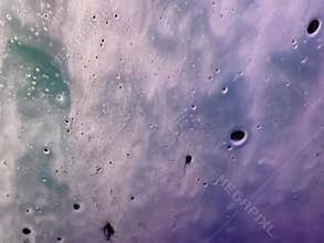Colorful soap suds wash off windshield inside car wash