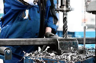 Industrial tehnician working on a drilling machine