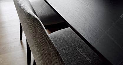 Closeup on modern chairs with upholstery and wooden dining table