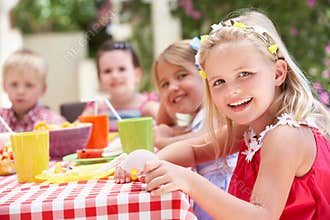Group Of Children Enjoying Outdoor Tea Party