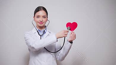 Female doctor cardiologist showing heart symbol