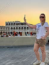 A woman wearing sunglasses poses at the Souk Waqif Market in Doha