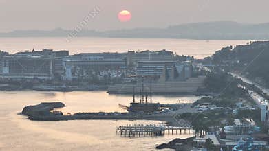 Stunning aerial sunset to night transition over Turkler in Alanya, Turkey. Alanya coastline,resorts,marina,hotels and city lights