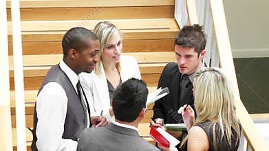 Business team speaking about work in stairs footage