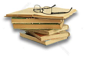 Stack of old books with glasses on white background