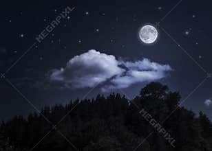 Night starry sky and moon over the mountain