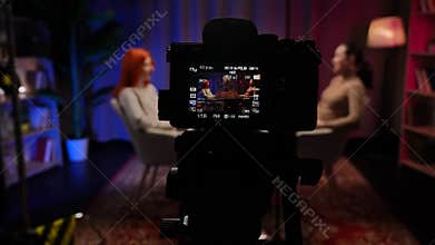 Two Influencers of women being interviewed in a loft-style podcast studio