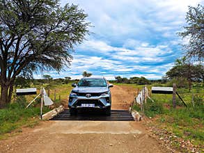 A gray Toyota Fortuner in the middle of the Namib Desert.