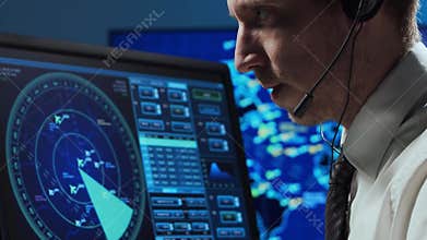 Professional air traffic controller in the control tower. Aircraft control officer works using radar, computer
