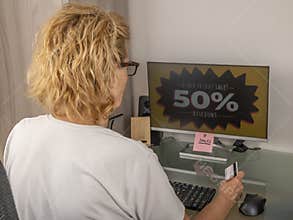 A blond woman takes advantage of Black Friday discounts to find good deals online