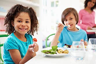 African American Family Eating Meal At Home Together