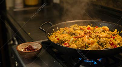 Warm Golden-Lit Paella with Seafood Chicken and Vegetables Simmering on Stovetop