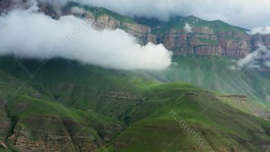 Caucasus mountains under moving clouds