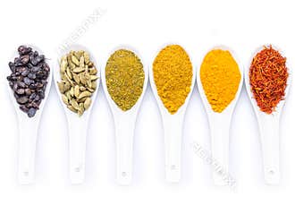 Diverse of spices in a spoon isolated on white background