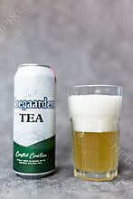 Bangkok, Thailand - May 6, 2026 : Glass of Hoegaarden TEA placed togeter with an aluminium tin Hoegaarden TEA, 500ml