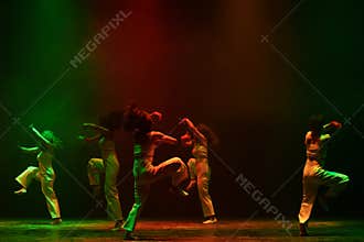 Contemporary Dance Ensemble Performing Dynamic Green and Red Stage Choreography