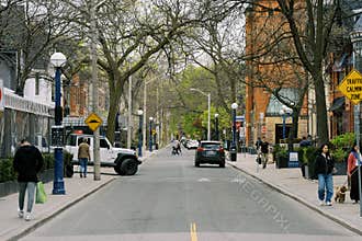 Toronto, Canada - May 12, 2026: Urban Street Scene with Pedestrians and Vehicles in Toronto