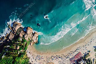 Joaquina beach in Florianopolis with rocks and ocean with waves. Aerial photo