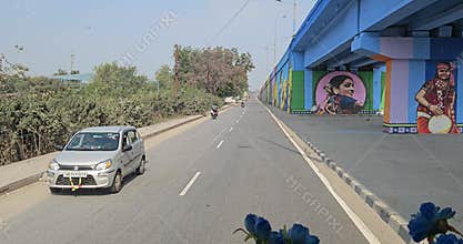 POV Driving Under Painted Flyover with Indian Murals