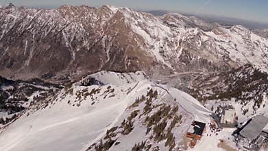 Aerial of Mountain Ridge line with People Standing by Buildings