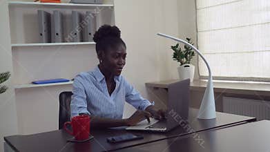 African female use pc at work.