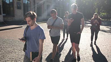 Students busy with smartphones on univesity campus