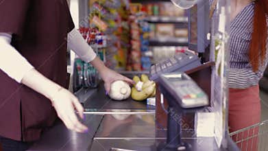 Point of sale.Cashier scans purchase products