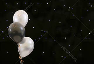 Party balloons on black