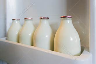 Milk Bottles in Fridge Door