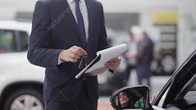 Salesman handing over the keys to happy customer