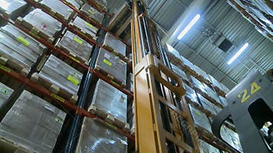 View of forklift lifts pallet in storage warehouse