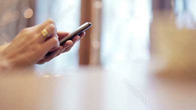 Woman hands texting, using smartphone in cafe.