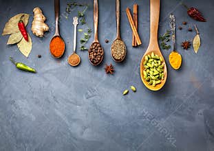 Various Spices near blackboard at blue stone background