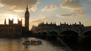 Sunsets behind Parliament as boat passes
