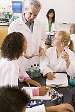School children and their teacher in science class