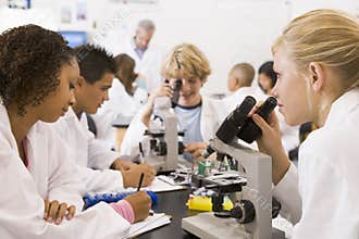 School children and their teacher in science class