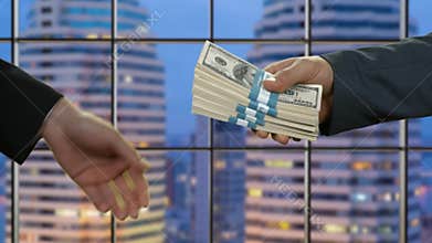 Hands of man pass dollars.