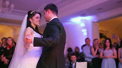 Beautiful bride and handsome groom dancing first dance at the wedding party