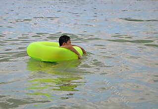 Boy in inflatable water toy