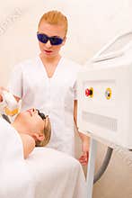 Woman getting light pulsed hair removal treatment