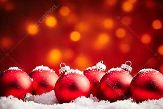 Red Christmas baubles sprinkled with snow