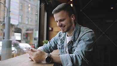 Happy man listening to music in earphones