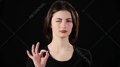 Thumbs up woman Happy giving success hand sign smiling joyful and happy. isolated on black background in studio