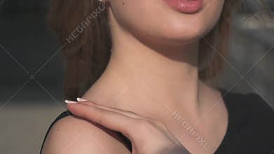 Close-up portrait of a charming girl with beautiful lips. Blonde in sunglasses posing at the camera. slow motion