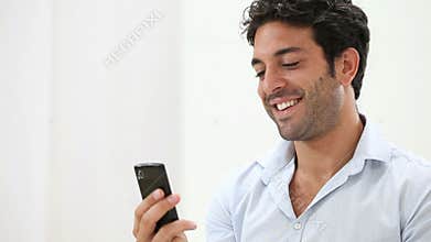 Happy guy chatting with smart phone