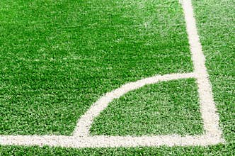 White corner field line on artificial green grass of soccer field