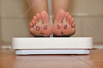 Feet on bathroom scale