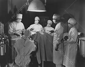 Team of surgeons perform operation