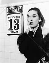 Young woman looking shocked after seeing Friday the 13th on a calendar