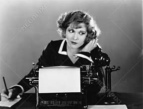 Woman at typewriter on telephone